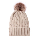 Knitted hat with plush padded fur ball