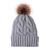 Knitted hat with plush padded fur ball